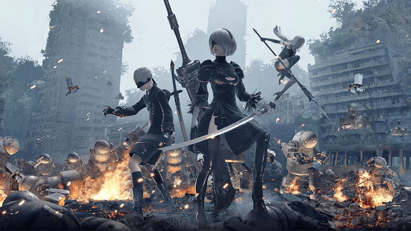 2B, 9S and A2 key art amid burning machines and ruined buildings