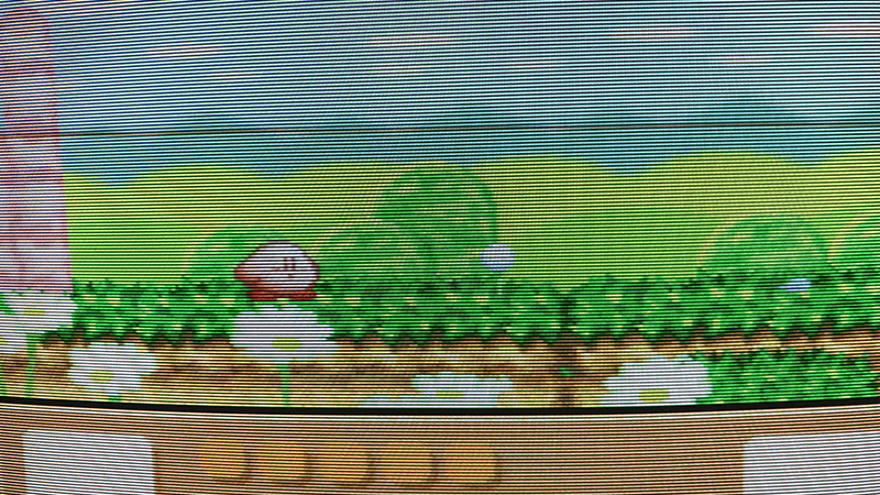 Kirby in a grassy field on CRT, soft vivid Super Famicom picture